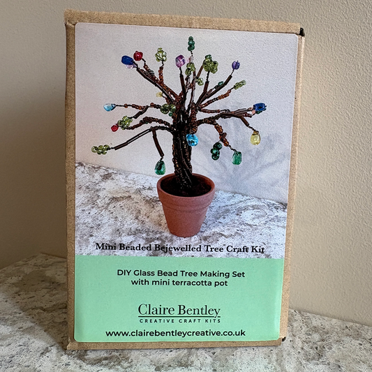 A cardboard box for a DIY class beaded tree making kit by Claire Bentley, featuring a printed photo of a finished beaded tree in a terracotta pot on the front.